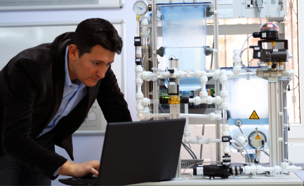 Engineer evaluating industrial automation equipment for upgrade and retrofit projects