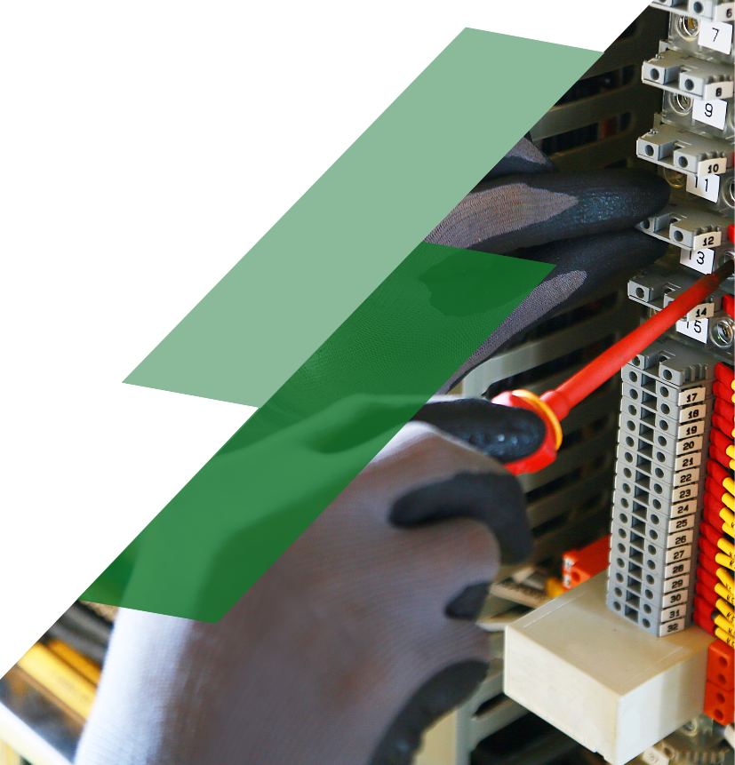 Technician troubleshooting an industrial control panel by servicing terminal blocks and electrical control components.
